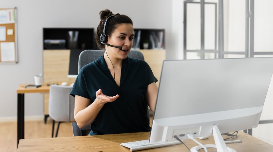 Professional virtual assistant working remotely on a laptop, managing emails and schedules for small businesses to improve productivity and efficiency in 2025.